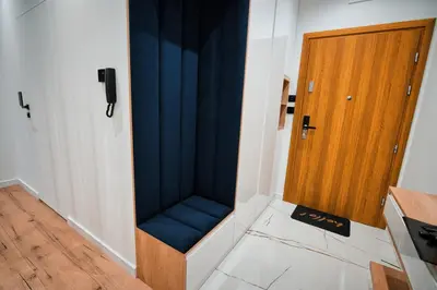 a room with a blue seat next to a door at Boutique 62 by Housine in Zator
