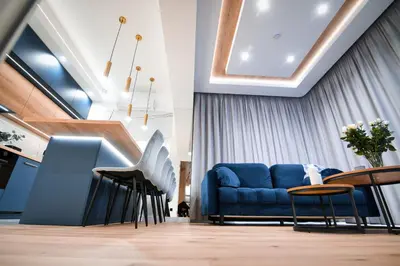 a living room with a blue couch and a table at Boutique 62 by Housine in Zator
