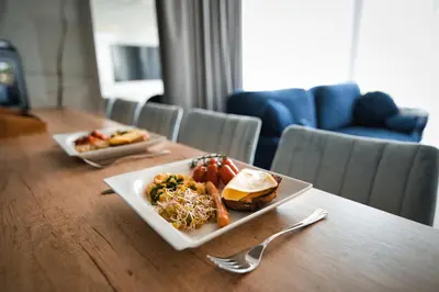 a table with a plate of food on a table at Boutique 62 by Housine in Zator