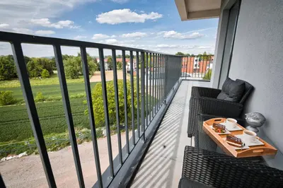 a balcony with a table and chairs and a view at Boutique 62 by Housine in Zator