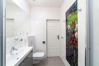 a bathroom with a sink and a shower curtain at MILU Apartments Kurkowa in Kraków