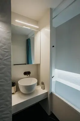 a bathroom with a large bowl sink and a mirror at Arcade Old Town with Free Parking in Kraków