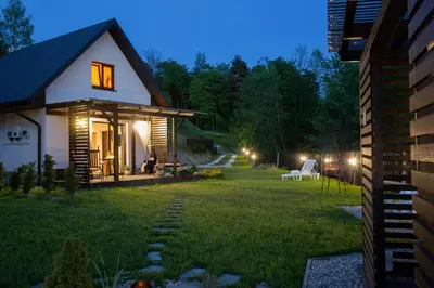 a bedroom with a large bed in a attic at Domki i tyle in Rabka
