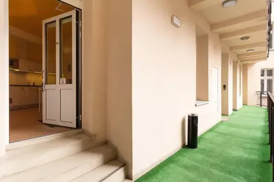 an empty hallway with green flooring in a building at Apartament w sercu krakowskiego Kazimierza in Kraków