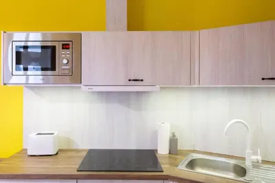 a kitchen with a sink and a microwave at Apartament w sercu krakowskiego Kazimierza in Kraków