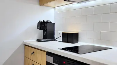 a kitchen with a coffee maker on a counter at Kana - Stylish Apartment in Kraków Pomorska - Close, WiFi, Smart TV in Kraków