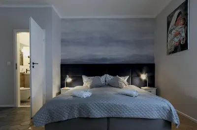 a bedroom with a large bed with two pillows on it at Kana - Stylish Apartment in Kraków Pomorska - Close, WiFi, Smart TV in Kraków