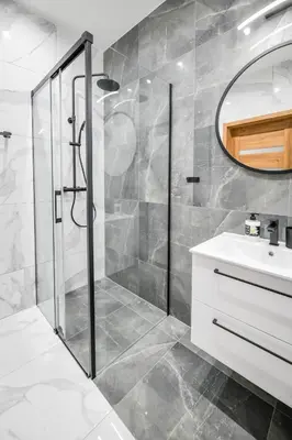 a bathroom with a shower and a sink at Apartament Komfort 17 in Zator