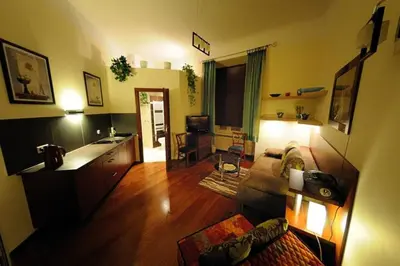 a living room with a couch and a table at Selene - Pantheon Apartments in Kraków