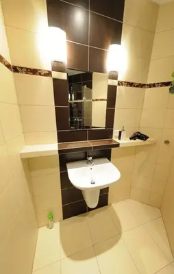 a bathroom with a sink and a mirror at Selene - Pantheon Apartments in Kraków