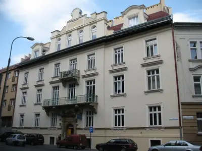 a large white building with cars parked in front of it at Selene - Pantheon Apartments in Kraków