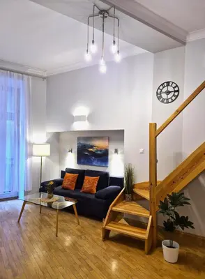 a living room with a couch and a table at Ariadna - Pantheon Apartments in Kraków