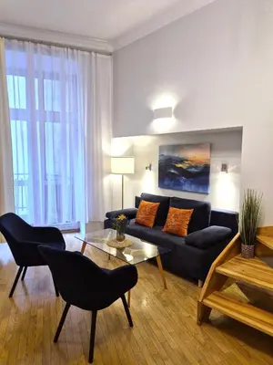 a living room with a couch and a table at Ariadna - Pantheon Apartments in Kraków