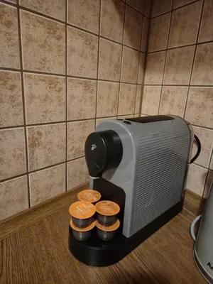a toaster sitting on a counter next to some coins at Ariadna - Pantheon Apartments in Kraków