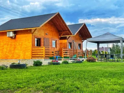 a wooden house with a lawn in front of it at Noclegi u Eli Zator Energylandia in Zator