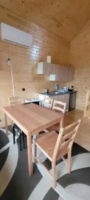 a wooden table and chairs in a room at Noclegi u Eli Zator Energylandia in Zator
