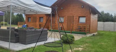 a small wooden house with a couch and a swing at Noclegi u Eli Zator Energylandia in Zator
