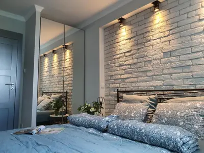 a bedroom with a brick wall and a large bed at Green Hill in Kraków