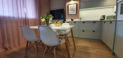 a kitchen with a table and chairs in a room at Green Hill in Kraków