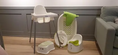 a childs bathroom with a baby toilet and a couch at Green Hill in Kraków