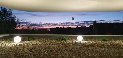 a view of a hot air balloon in the sky with lights at Green Hill in Kraków