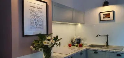 a kitchen with a vase of flowers on a counter at Green Hill in Kraków