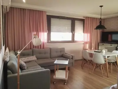 a living room with a couch and a table at Green Hill in Kraków