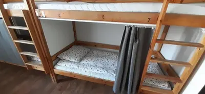 a bunk bed with a mattress on the bottom bunk at Kraków Chilli Hostel in Kraków