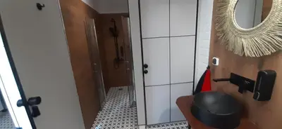 a bathroom with a mirror and a toilet at Kraków Chilli Hostel in Kraków