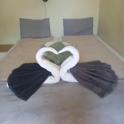 two swans making a heart on a bed at Kraków Chilli Hostel in Kraków