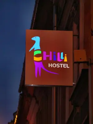 a sign for a chiu hostel on the side of a building at Kraków Chilli Hostel in Kraków