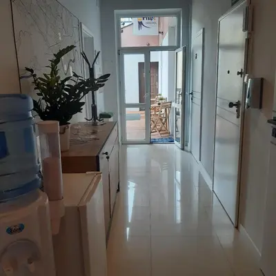 a kitchen with a hallway with a view of a balcony at Kraków Chilli Hostel in Kraków