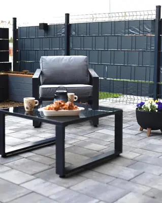 a coffee table and a couch on a patio at Apartament LUX in Zator