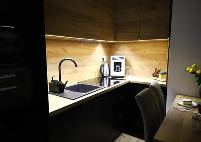 a small kitchen with a sink and a microwave at Apartament LUX in Zator