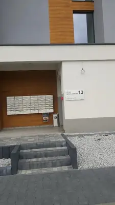 a building with stairs in front of a door at Apartament LUX in Zator