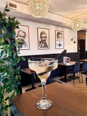 a martini glass sitting on a table in a restaurant at VANTA Business Center in Skawina