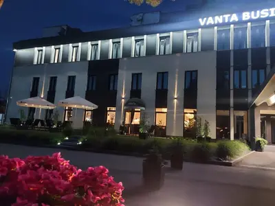 a building with a bunch of flowers in front of it at VANTA Business Center in Skawina