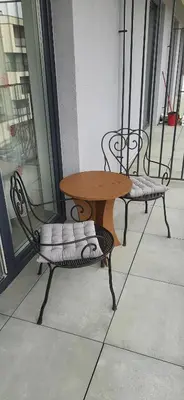 two chairs and a table on a balcony at Apartament 59 JUSTI in Zator