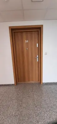 a large wooden door in an empty room at Apartament 59 JUSTI in Zator