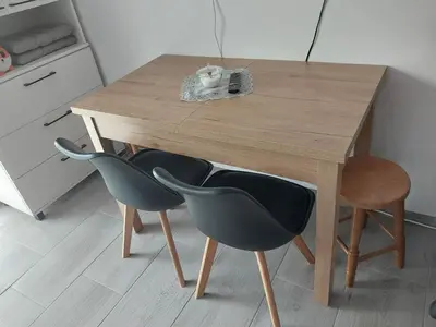 a wooden table with two chairs and a wooden table at Apartament 59 JUSTI in Zator