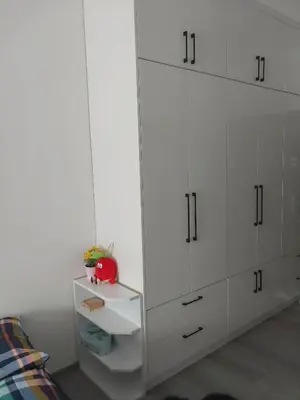 a bedroom with white cabinets and a bed at Apartament 59 JUSTI in Zator