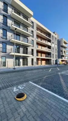 a yellow frisbee on a street in front of a building at Apartament 59 JUSTI in Zator