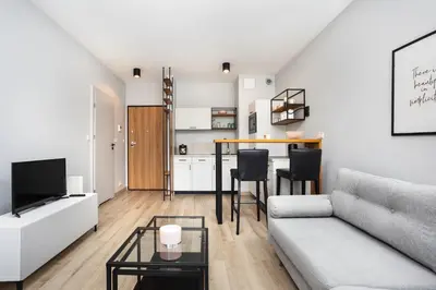 a living room with a couch and a table at City of the Kings-Alice Apartment in Kraków