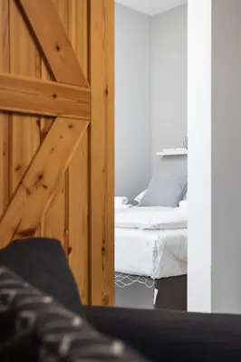 a bedroom with two beds and a wooden door at City of the Kings-Alice Apartment in Kraków