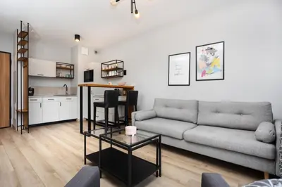 a living room with a couch and a table at City of the Kings-Alice Apartment in Kraków