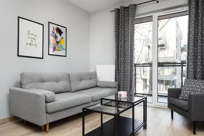 a living room with a couch and a table at City of the Kings-Alice Apartment in Kraków