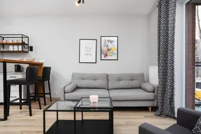 a living room with a couch and a table at City of the Kings-Alice Apartment in Kraków