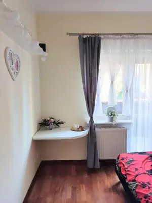 a room with a window with a curtain and a table at *** Cozy and bright apartment (over 50m2) *** in Kraków