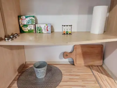 a wooden table with a vase on a floor at *** Cozy and bright apartment (over 50m2) *** in Kraków
