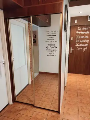 a glass door in a room with a sign on the wall at *** Cozy and bright apartment (over 50m2) *** in Kraków